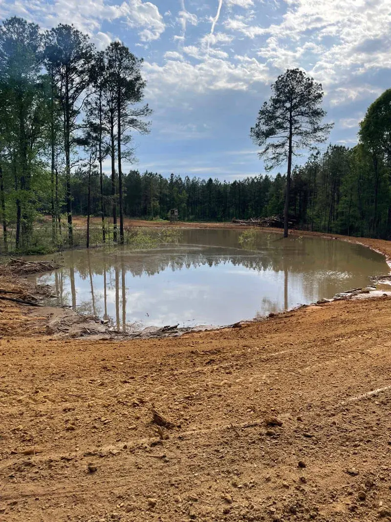 Pond bank shaping and final grading — farm pond construction Mississippi